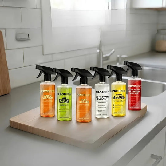 Set of Proszek cleaning products on a kitchen counter with a tiled wall background.
